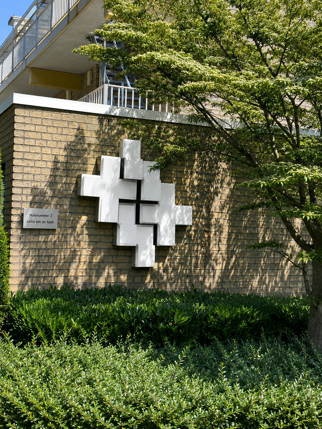 Building exterior with four crosses. The entrance to Salbar Fysiotherapie is to the right of the four crosses
